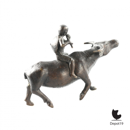 Traditional_Antique_Bronze_Asian_sculpture_of_a_boy_flute_player_riding_the_Bull_Home__Depot19_vintage_design_classics_8.jpeg
